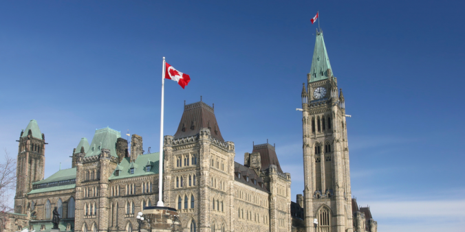 Government of Canada Parliament Buildings with a blue sky behind the buildings.